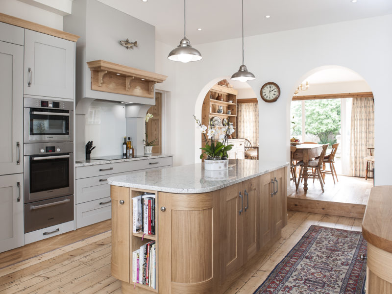 grey kitchen with wood floor and rug