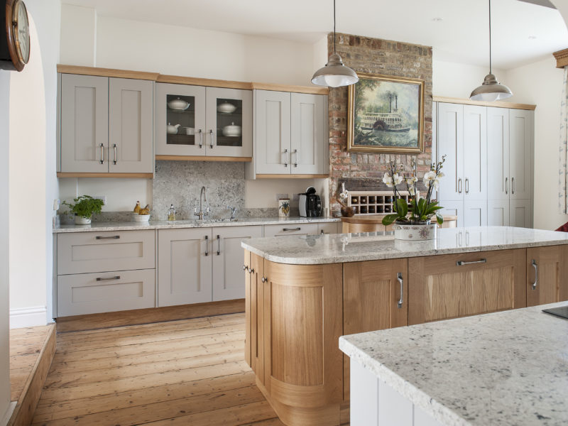 grey kitchen with wood floor and island