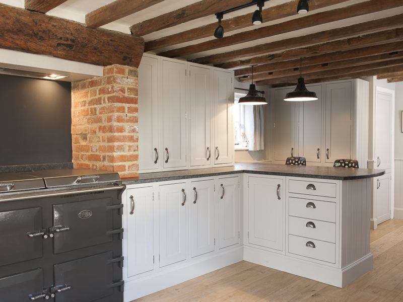 cottage kitchen with pendant lamps and range cooker