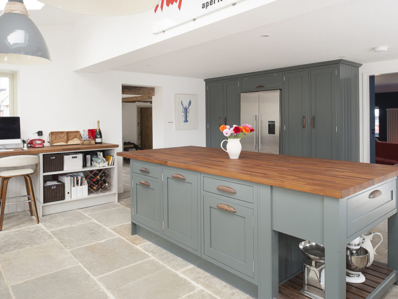 kitchen with stone floors and pendant lamp