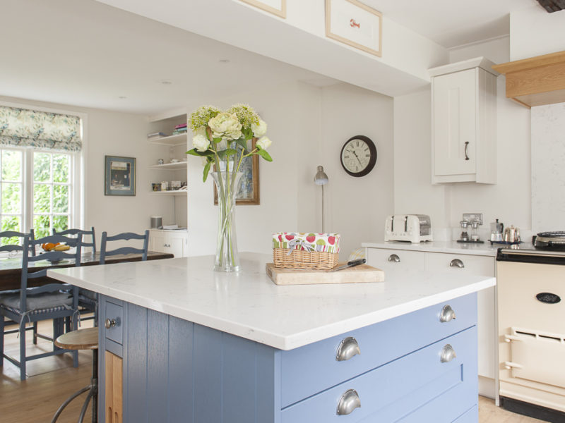 kitchen with blue island and range cooker