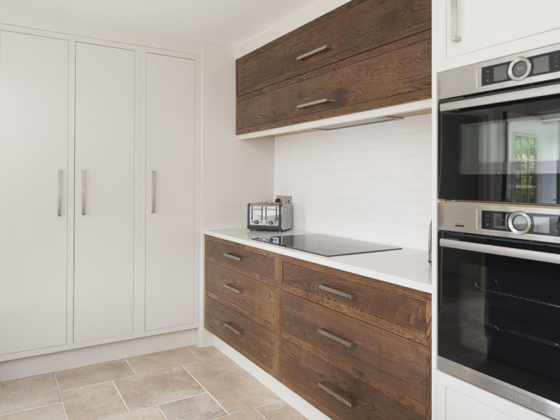 white kitchen with wood accents and tiled floor