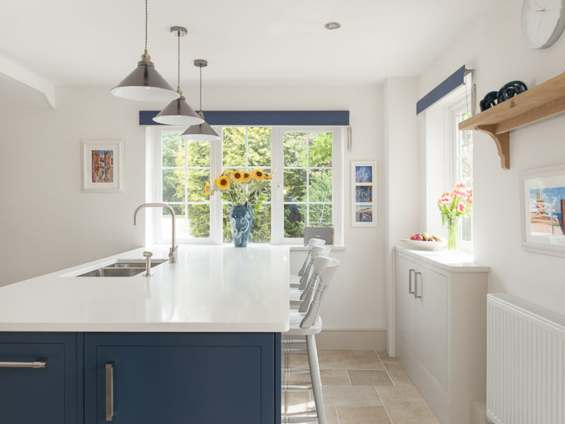 light and airy kitchen with blue island