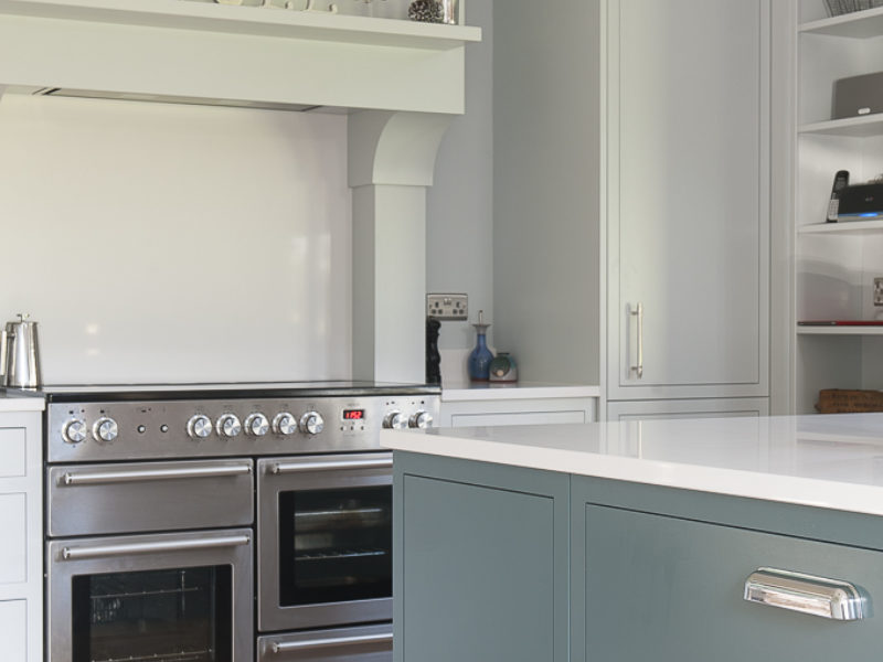 modern country kitchen with blue island and range cooker
