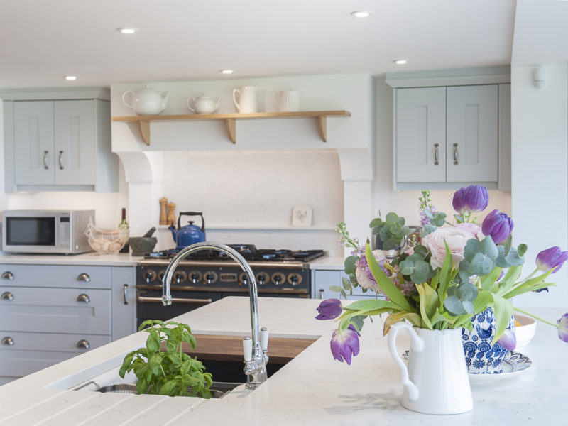 farmhouse kitchwn with swan neck tap and flowers