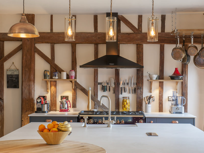 kitchen with oven hood and pendant lamps