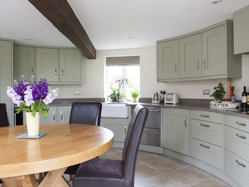 cottage kitchen with beams and wood dining table