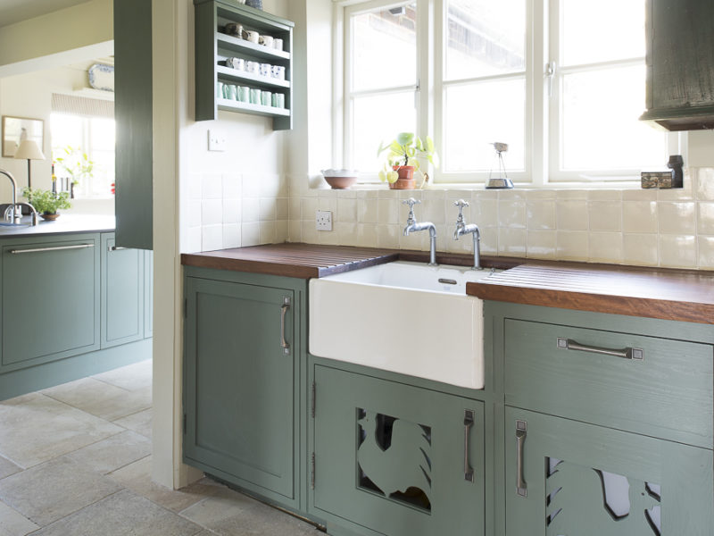 green kitchen with belfast sink