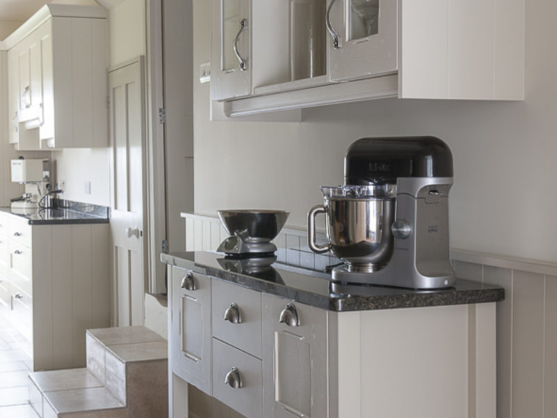 galley kitchen with freestanding storage